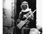 The Viol has only one string and its bow is home-manufactured. An early photograph.